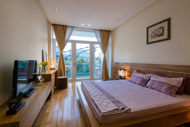Phòng ngủ riêng tư đặt ở tầng 2 với khung cửa lớn giúp lấy ánh sáng tự nhiên.