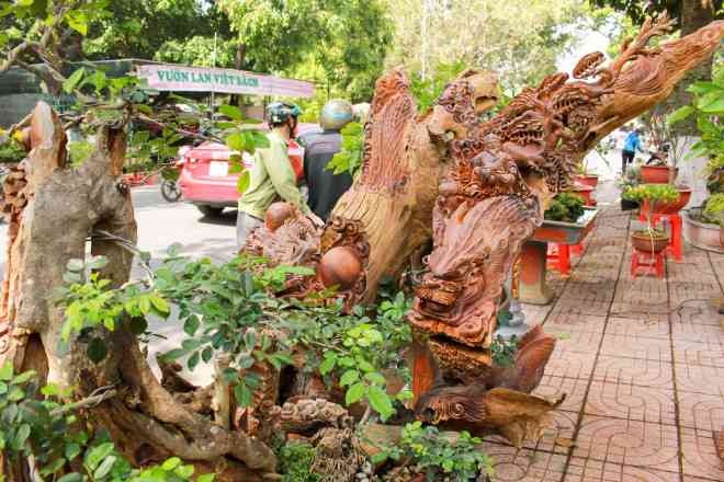 Để chậu bon sai thêm giá trị, anh Tuấn đã thuê nghệ nhân đục nổi 8 con cá chép, tạo hình 3 đầu rồng ngậm ngọc lớn&nbsp;cùng nhiều họa tiết khác.