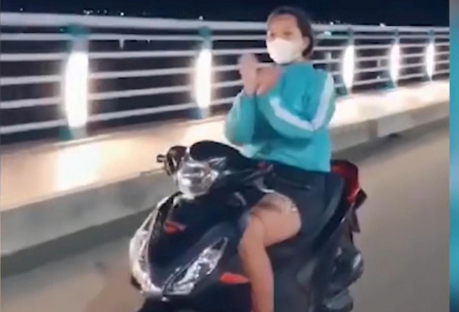 Cô gái ở Quảng Ngãi thả 2 tay khi đi xe máy. Ảnh cắt từ clip