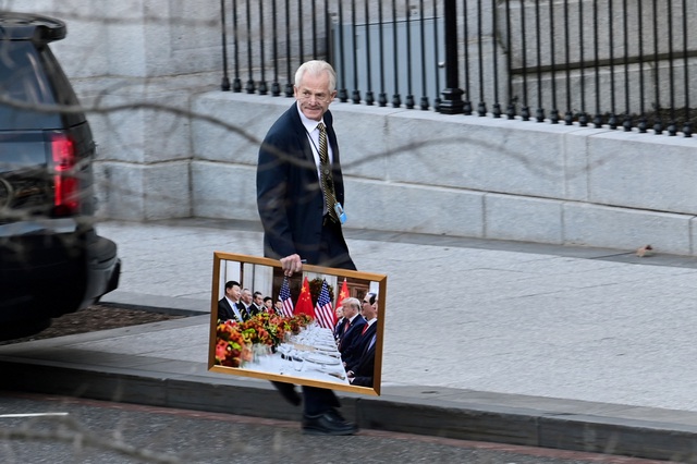 Peter Navarro - trợ lý của Tổng thống Trump - mang bức chụp cuộc gặp của hai phái đoàn Mỹ và Trung Quốc do Tổng thống Trump và Chủ tịch Tập Cận Bình dẫn đầu, rời Nhà Trắng (ảnh: Reuters)