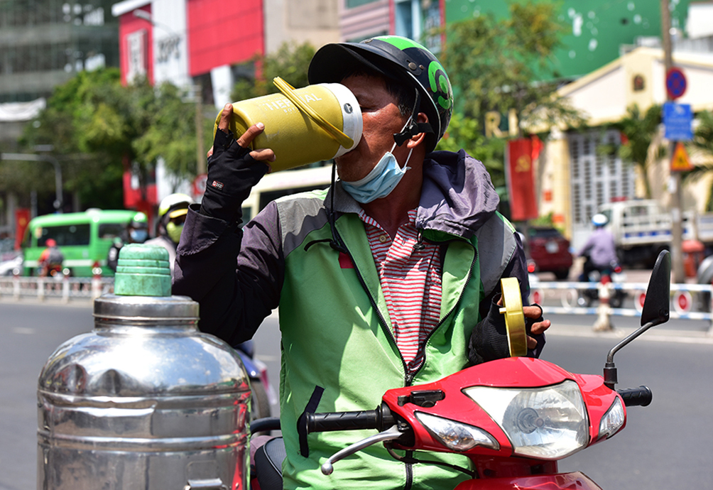 Ông Nguyễn Văn Dũng, tài xế xe ôm công nghệ ghé đến bình nước miễn phí trên đường Nguyễn Thái Học, quận 1 để uống, lấy thêm nước. “Sáng nay đi làm tôi mang bình 1,5 lít nhưng đến trưa thì đã uống hết. Khi chạy ngoài đường hay đứng chờ khách trong bóng râm mấy ngày nay đều rất nóng bức, mất nước rất nhanh nên phải uống liên tục để giải nhiệt”, bác tài này cho hay.