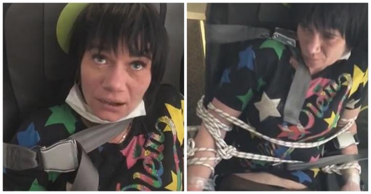 Người phụ nữ bị trói lại sau khi lột đồ trên máy bay ở Nga. Ảnh: Youtube