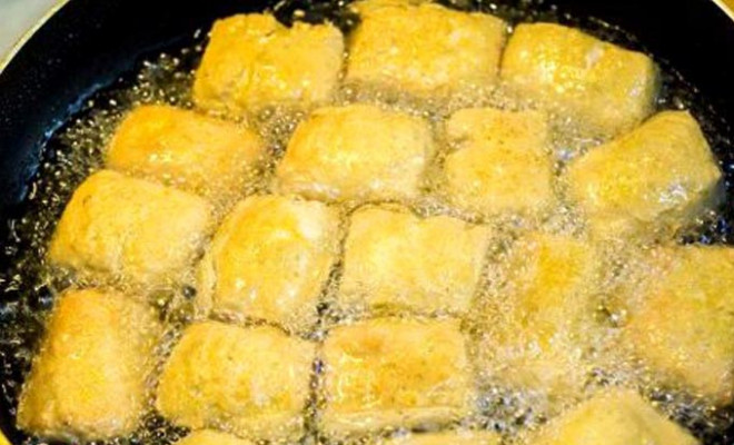 Đậu lướt ván chiên trong chảo nhiều dầu. Ảnh minh họa.