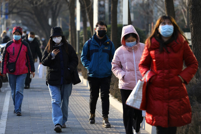 Người dân đi lại trên đường phố trong giờ cao điểm ở thủ đô Bắc Kinh, Trung Quốc hôm 18-1 Ảnh: Reuters