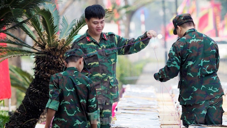 Các chiến sĩ lắp đặt hệ thống kích nổ tại trận địa pháo hoa, kiểm tra từng chi tiết để đấu nối vào bệ phóng.