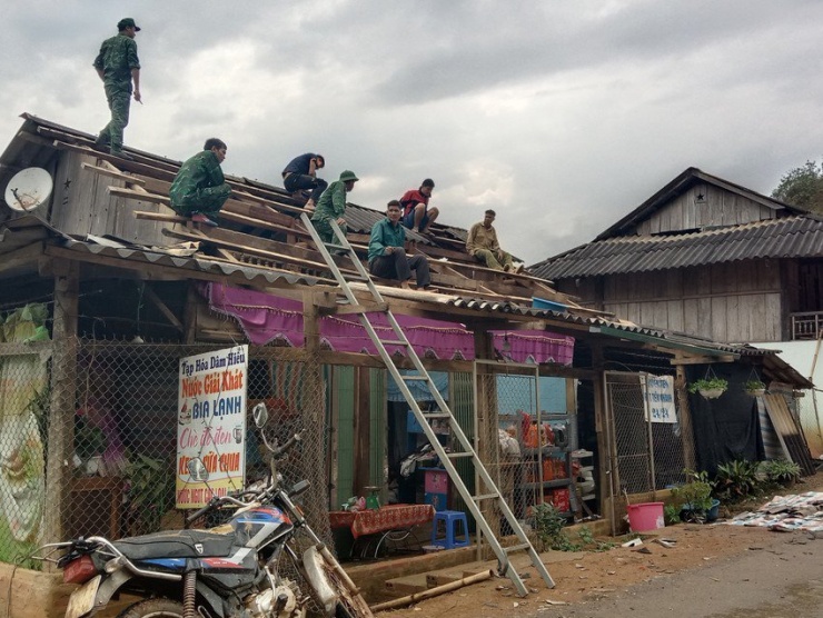 Lực lượng chức năng huyện Sốp Cộp hỗ trợ người dân khắc phục hậu quả trận mưa đá, gió lốc. Ảnh PV