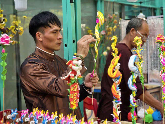 Các nghệ nhân nặn tò he khéo léo trở thành "thỏi nam châm" hút các khách tham quan nhí.