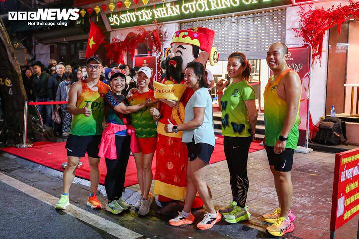 Nhiều người đi tập thể dục buổi sáng tỏ ra thích thú trước không khí sôi động của ngày vía thần Tài, tranh thủ chụp ảnh cùng linh vật thần Tài để cầu may đầu năm.