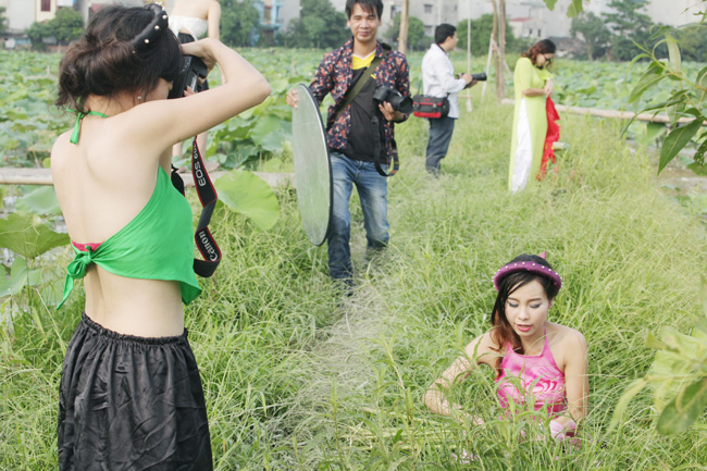 Không chỉ lội bùn, họ còn phải chui vào trong cọ, chen chúc trong một không gian đông đúc để có được những góc máy đẹp mà không bị chen hình người khác.&nbsp;