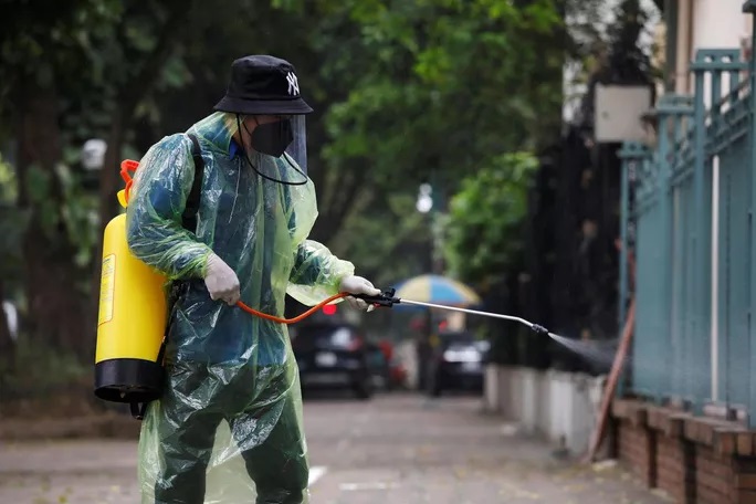 Nhân viên xịt khử trùng tại Hà Nội vào cuối tháng 3. Ảnh: Reuters