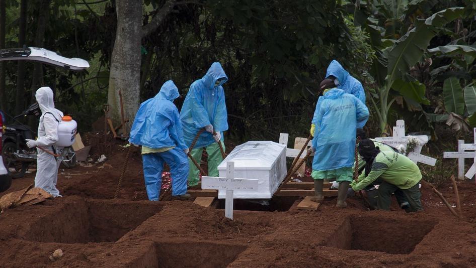 Nhân viên y tế vừa khử trùng vừa chôn cất nạn nhân Covid-19 tại Indonesia (ảnh: ABC News)