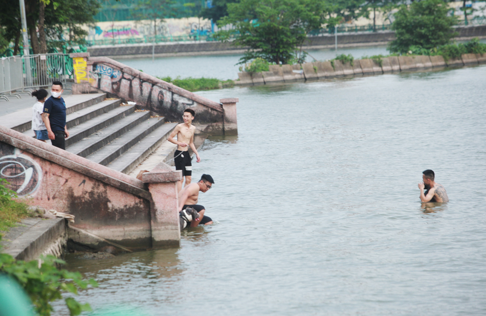 Tại các bến tắm tự phát ở Hồ Tây, mặc dù cơ quan chức năng ở phường Nhật Tân (quận Tây Hồ) đã lập hàng rào barie và treo biển hiệu “cấm tụ tập đông người” nhưng một số người dân vẫn bất chấp leo qua hàng rào để xuống hồ bơi lội.