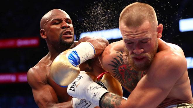 Mayweather (trái) châm biếm quyết định nghỉ hưu của McGregor (phải)