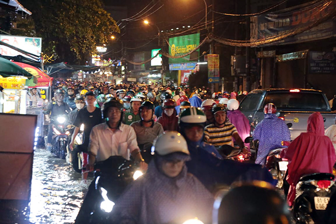 Cơn mưa lớn khoảng 40 phút xảy ra vào giờ tan tầm khiến người Sài Gòn hứng trọn "combo” ngập nước, kẹt xe.