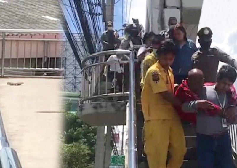 Cảnh sát và lực lượng cứu hộ giải cứu người đàn ông (áo đỏ) có ý định nhảy cầu tự tử. Ảnh: ANN