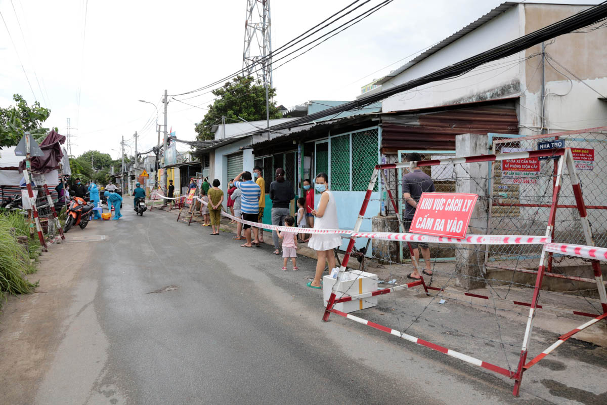 Sau khi lực lượng quân đội hoàn thành khử khuẩn, người dân trong khu cách ly ra ngoài chờ lấy mẫu xét nghiệm.