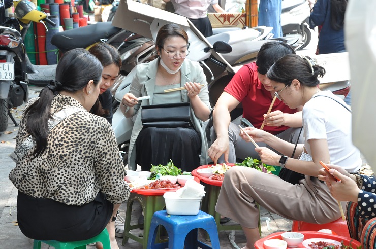 Khoảng 11 giờ trưa, hàng sứa đỏ nhỏ xíu đã chật kín khách, 4 thành viên trong gia đình bà Lập luôn tay luôn chân phục vụ. Người thì cắt sứa, người cắt đậu, người thái cùi dừa, người bưng bê cho khách.