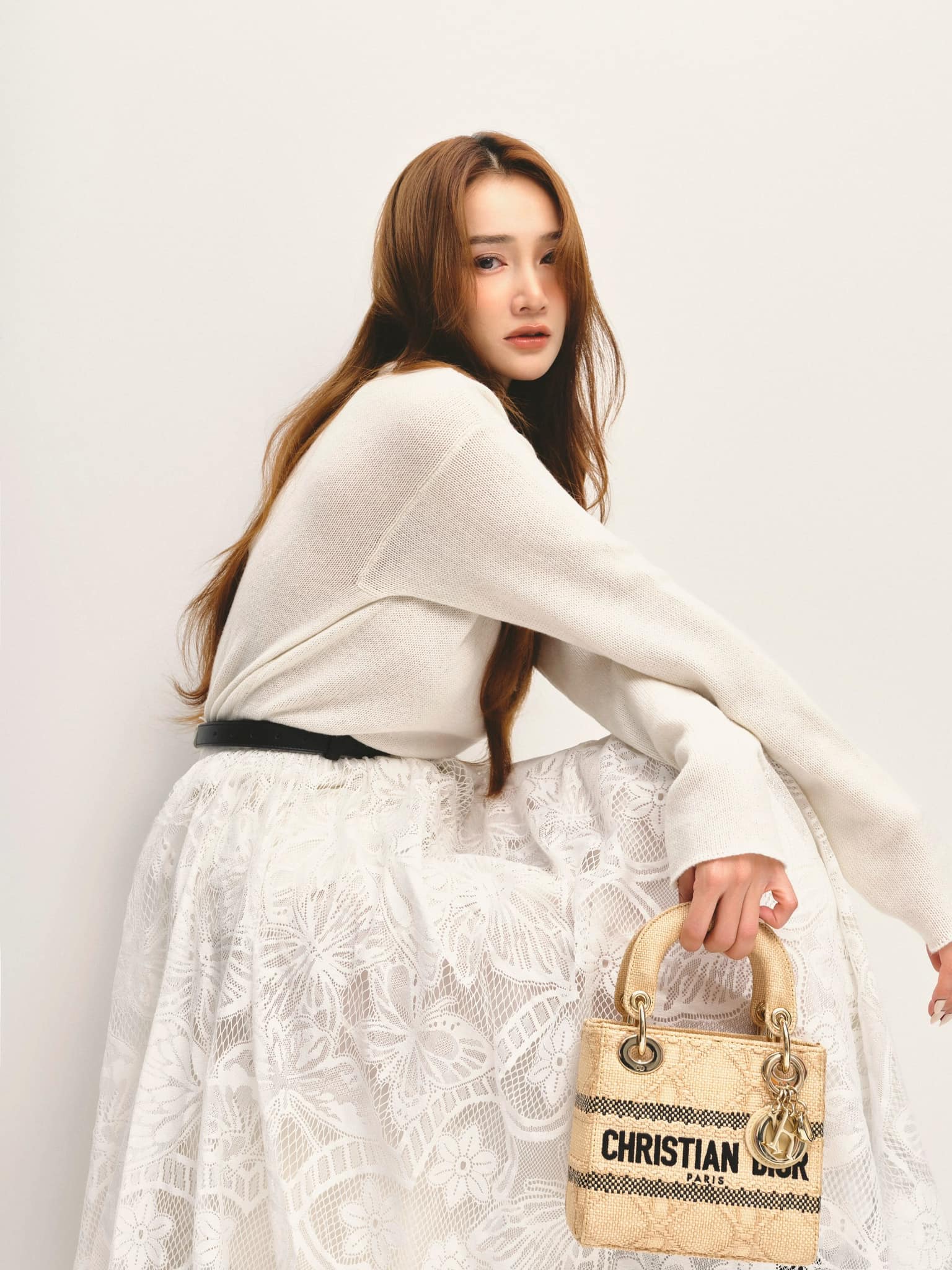 Trên tay nữ diễn viên là chiếc túi Dior Lady D-Lite thuộc dòng&nbsp;Natural Cannage Raffia, có giá hơn 120 triệu đồng.
