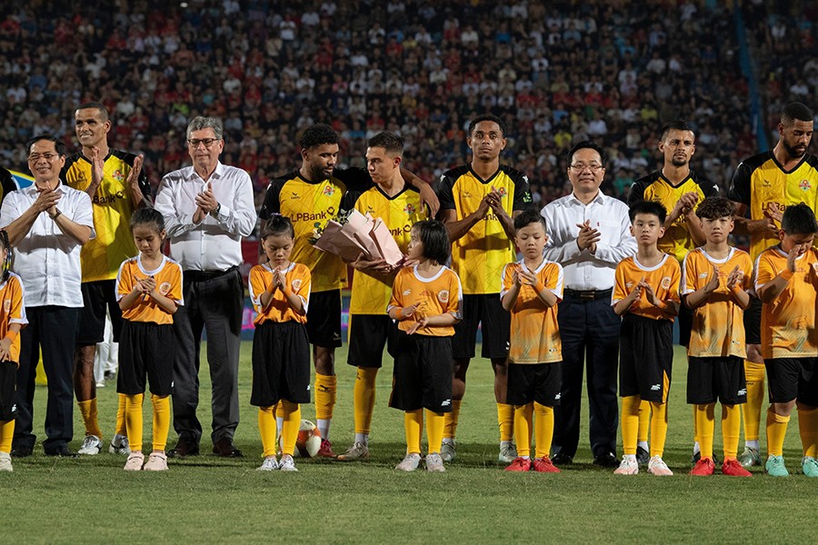 Ông Hoàng Văn Phúc (áo trắng từ phải sang) - Phó Tổng Giám đốc đại diện LPBank tặng hoa các cầu thủ trước trận đấu.