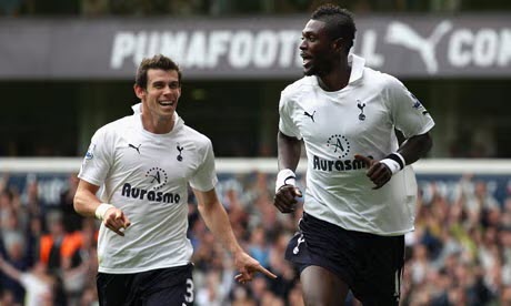 Adebayor (right) celebrates his double against Liverpool with Bale, right in his White Hart Lane debut