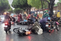 Hàng loạt xe máy trượt ngã trong mưa