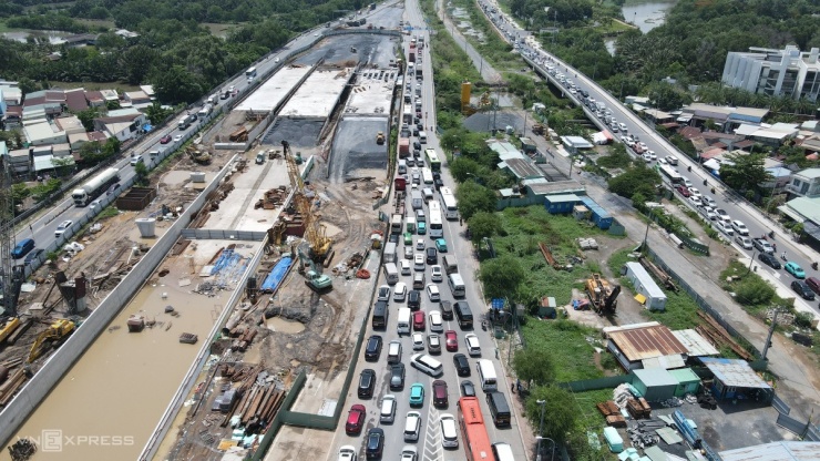 Từ 8h, dòng ôtô xếp hàng dài qua nút giao An Phú để vào cao tốc TP HCM - Long Thành - Dầu Giây. Do một giờ trước, ôtô đầu kéo chết máy trên cầu Long Thành, chắn hết một làn đường cao tốc nên tuyến này bị kẹt xe kéo dài 10 km.