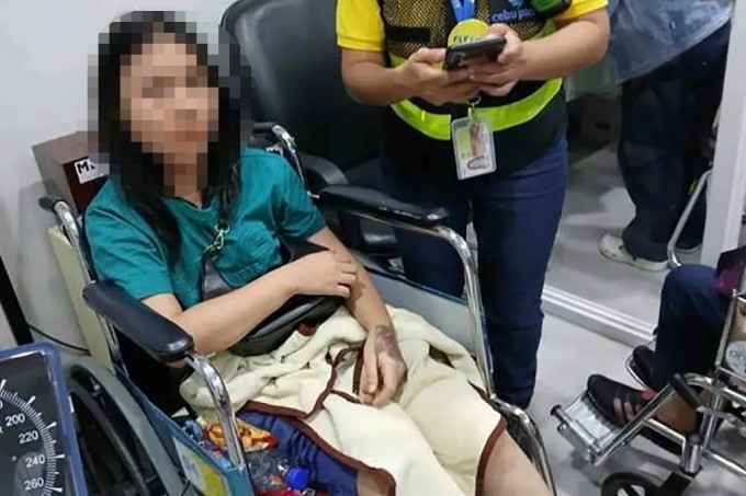 Nữ hành khách được nhân viên hãng hàng không Cebu Pacific hỗ trợ mặc quần áo và ổn định tâm lý sau màn khỏa thân. Ảnh: Viral Press