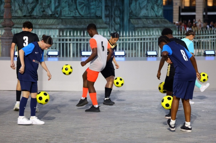 Các thành viên của đội tuyển bóng đá nam và nữ quốc gia Pháp chơi bóng trên đường phố.