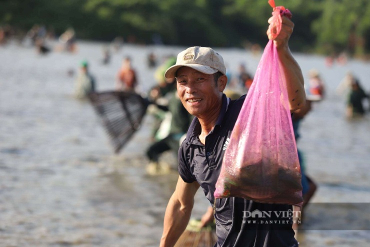 Người dân chia sẻ niềm vui sau khi bắt được những con cá tươi ngon.