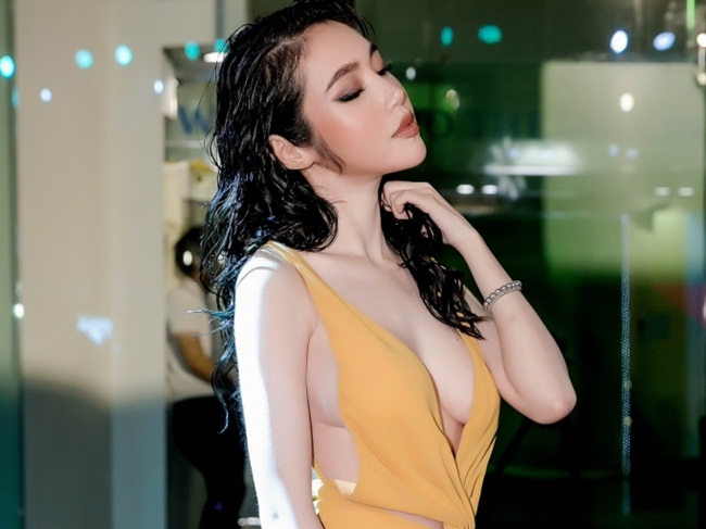 Chiếc váy màu vàng của NTK Hoàng Minh Hà với những đường cắt xẻ táo bạo giúp Elly Trần khoe khéo vòng một gợi cảm cùng làn da trắng ngần.  