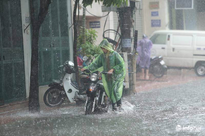 Tại phố Vương Thừa Vũ, nước điểm ngập sâu nhất khoảng 60cm, rất nhiều phương tiện chết máy phải dắt bộ.&nbsp;