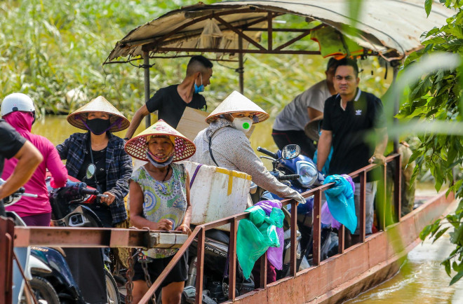 Một số người dân đang sử dụng đò cho việc di chuyển qua lại giữa khu vực Chương Dương và bãi giữa sông Hồng