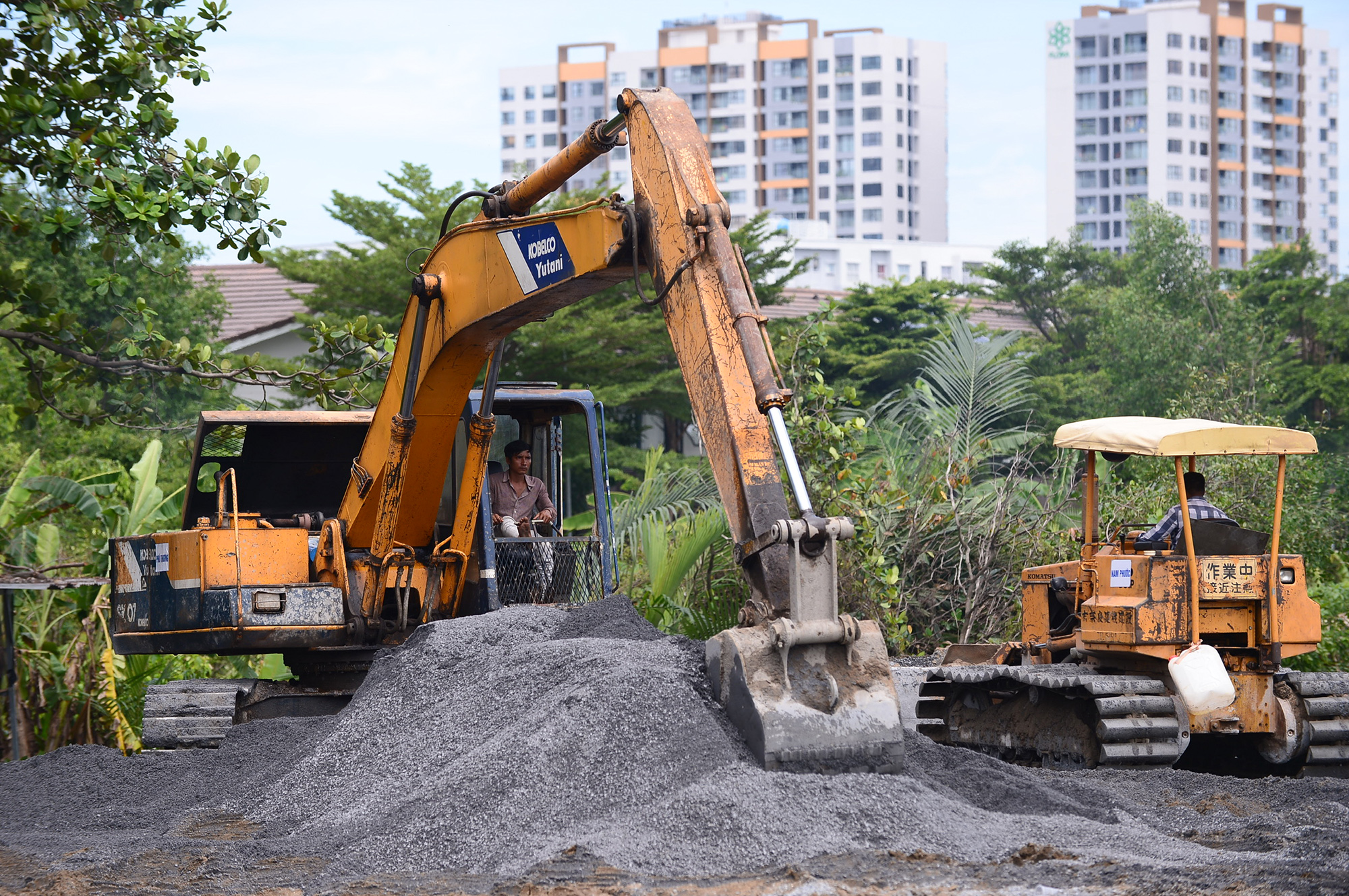 Bên trong công trình, hàng chục xe cuốc, xe lu hoạt động hết công suất để tạo mặt bằng.