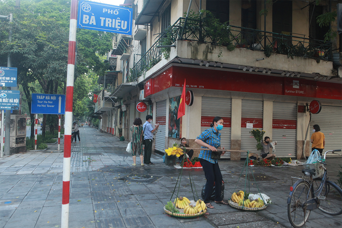 Nhiều người bán hoa, hoa quả trên vỉa hè phố Bà Triệu (ảnh chụp lúc 6h15 sáng 24/7).