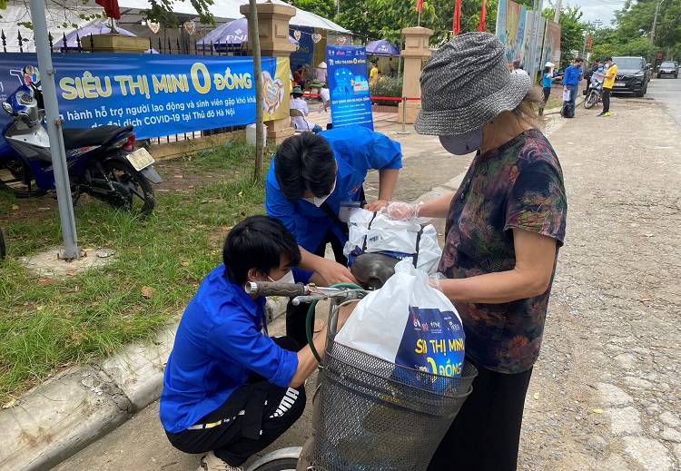 Các bạn tình nguyện viên nhiệt tình giúp đỡ người dân mua sắm lương thực thực phẩm.