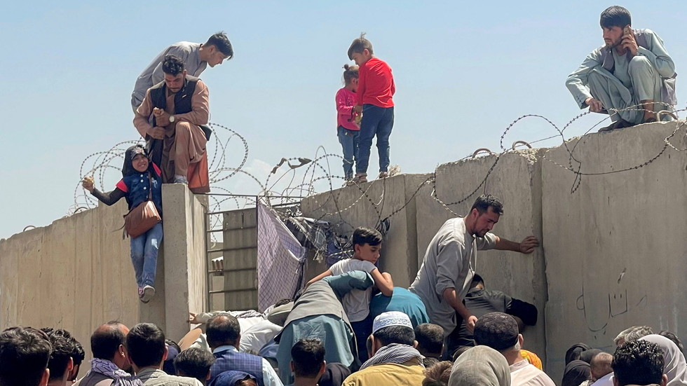 Người dân Afghanistan cố gắng vượt rào ở sân bay Kabul.