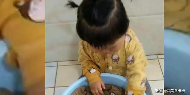 Bé gái 2 tuổi tỉ mẩn giặt quần cho bố.