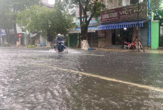Nước ngập nửa bánh xe trên đường Trần Phú. Ảnh: Tấn Việt
