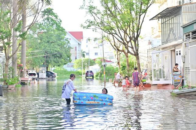 Nhiều gia đình còn mua phao về cho trẻ bơi lội trên phố.