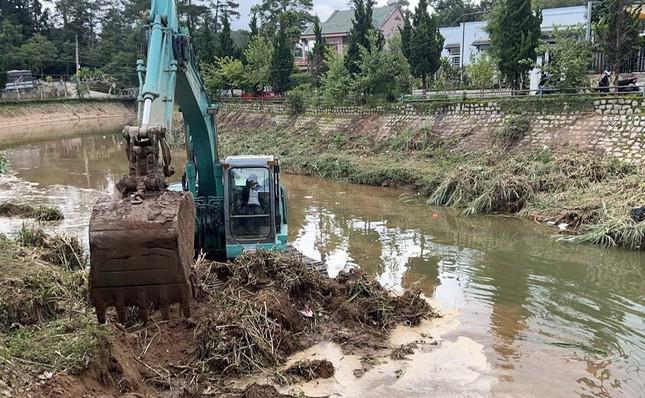 Huy động phương tiện cơ giới dọn cỏ rác trong lòng suối