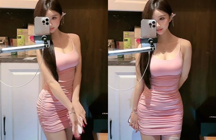 Hot girl này diện một chiếc váy hai&nbsp;dây màu hồng. Thiết kế vừa vặn ôm sát vào body giúp tôn đường cong nóng bỏng.
