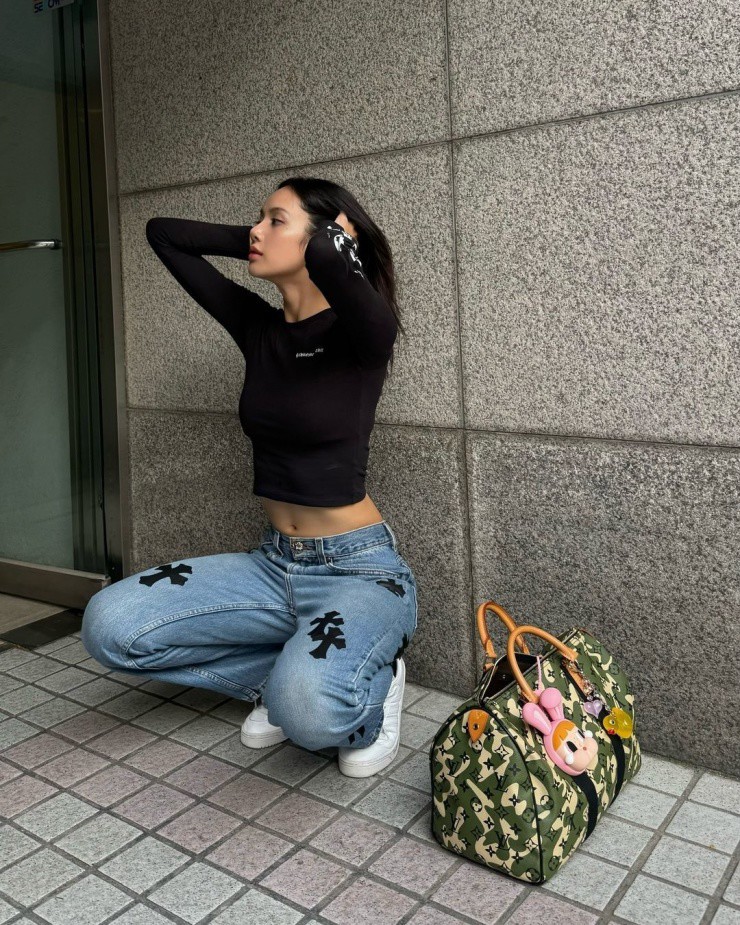 Khi dạo phố, mua sắm hôm 1/8, cô cũng chọn áo thun crop top, kết hợp quần jeans và túi Louis Vuitton.