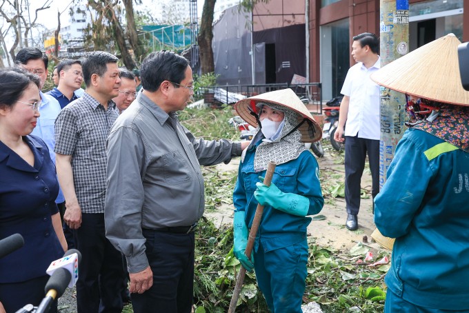 Thủ tướng thăm, động viên công nhân vệ sinh môi trường đang làm nhiệm vụ. Ảnh: VGP/Nhật Bắc