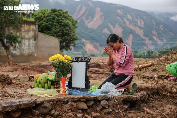 Chị Phương bên cạnh bàn thờ tạm ngay trên nền nhà cũ của bà Mai.