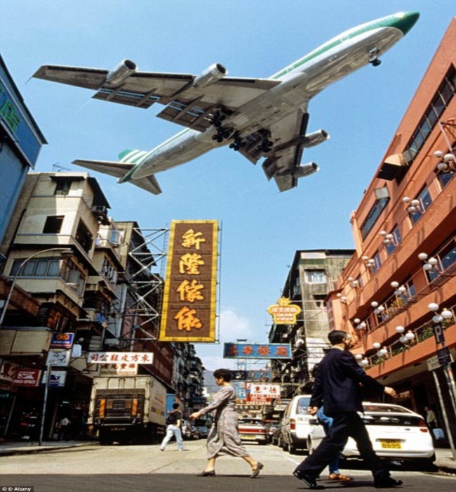 Máy bay lướt sát qua các tòa nhà trong khi hạ cánh xuống sân bay Kai Tak ở Hong Kong.