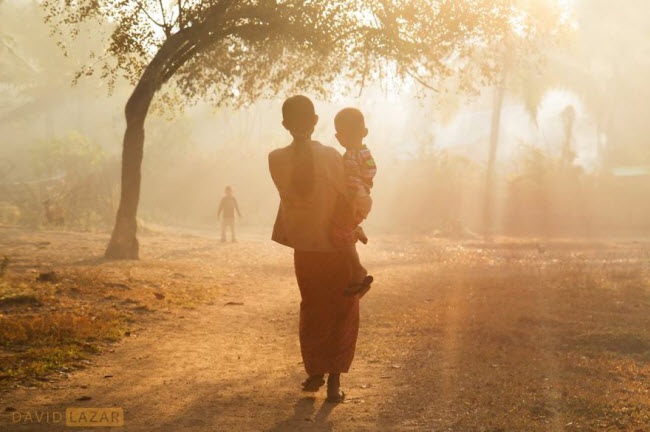 Mẹ bế con nhỏ đi dưới sương sớm ở Mrauk