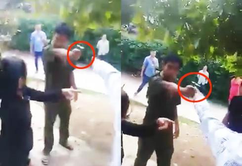 Phó Trưởng Công an xã Tiên Lãnh Phạm Hồng Tiền chĩa súng vào người dân. Ảnh cắt từ clip