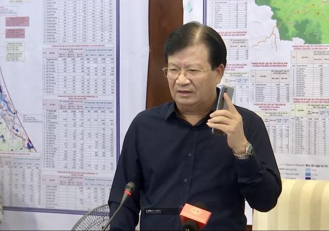 Phó Thủ tướng Trịnh Đình Dũng nghe điện thoại của Thủ tường Nguyễn Xuân Phúc chỉ đạo ứng phó bão số 9 vào lúc 11h30 đêm 27/10. Ảnh: Đình Thiên