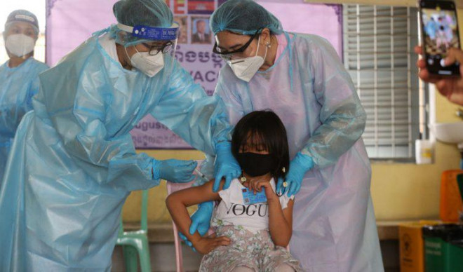 Một bé gái được nhân viên y tế tiêm chủng tại Campuchia. Ảnh: Khmer Times