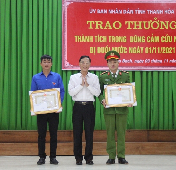 Phó Chủ tịch UBND tỉnh Thanh Hoá Đầu Thanh Tùng trao bằng khen cho thượng uý Hải và anh Bình vì đã có hành động cứu sống bé gái bị đuối nước. Ảnh Báo Thanh Hoá.